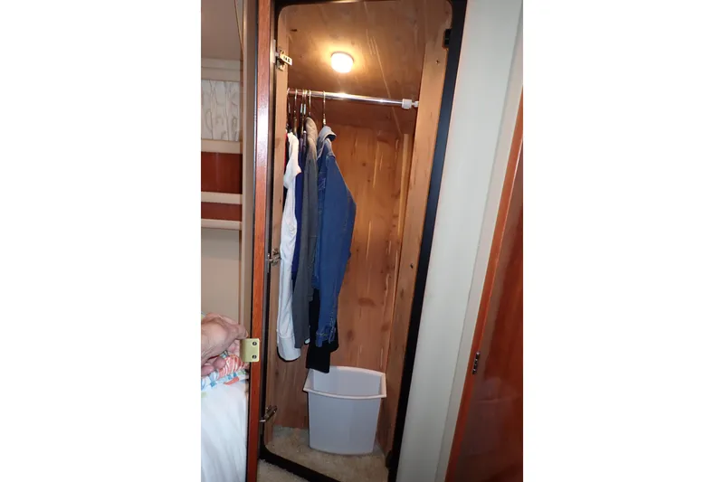 Lattitude Adjustment Yacht Photos Pics Closet interior on 2003 Sea Ray 480 Sedan Bridge yacht with hanging clothes and a bin.