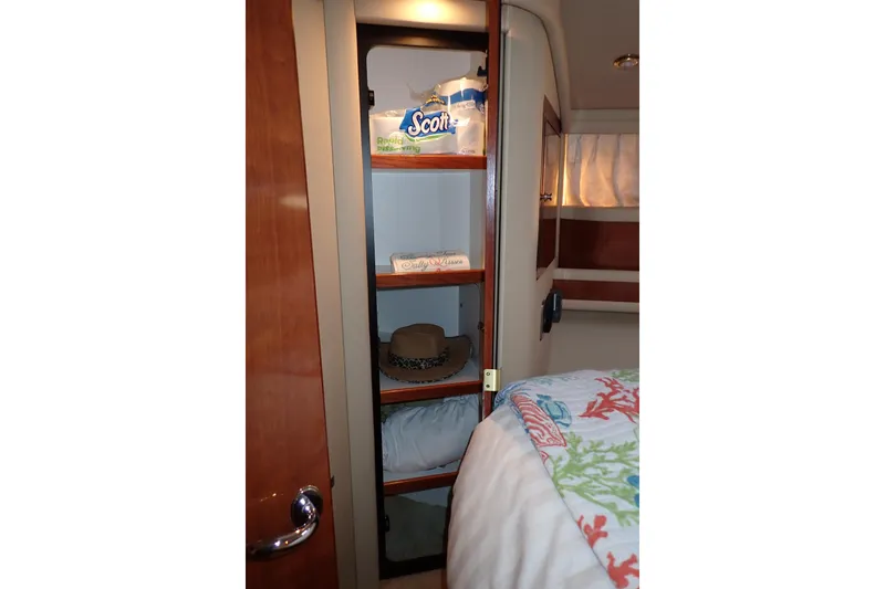 Lattitude Adjustment Yacht Photos Pics Cabin storage in 2003 Sea Ray 480 Sedan Bridge yacht with shelves and bedding.