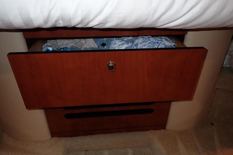 Lattitude Adjustment Yacht Photos Pics Open wooden drawer with clothes inside on a 2003 Sea Ray 480 Sedan Bridge.