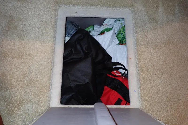 Lattitude Adjustment Yacht Photos Pics Storage compartment on 2003 Sea Ray 480 Sedan Bridge with various bags and items.