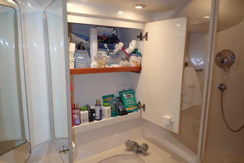 Lattitude Adjustment Yacht Photos Pics Bathroom cabinet with toiletries on a 2003 Sea Ray 480 Sedan Bridge yacht.