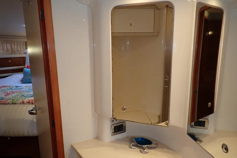 Lattitude Adjustment Yacht Photos Pics 2003 Sea Ray 480 Sedan Bridge bathroom with mirror and sink, adjacent to bedroom.