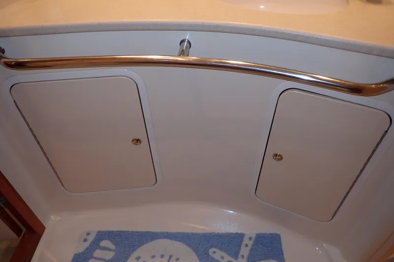 Lattitude Adjustment Yacht Photos Pics 2003 Sea Ray 480 Sedan Bridge bathroom with storage cabinets and blue mat.