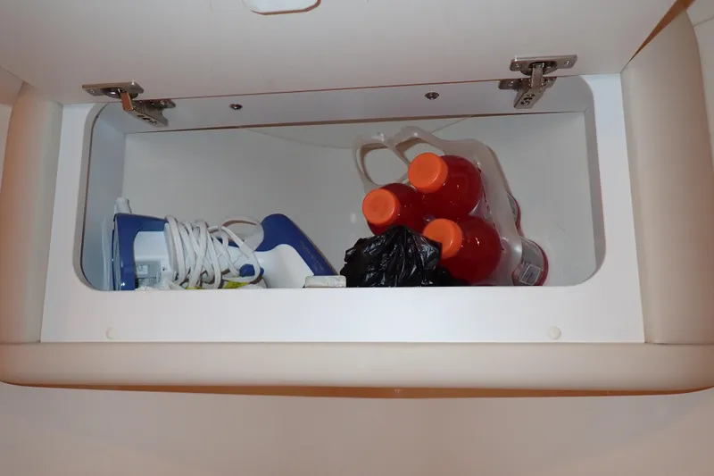 Lattitude Adjustment Yacht Photos Pics Storage compartment in 2003 Sea Ray 480 Sedan Bridge with iron and drinks.