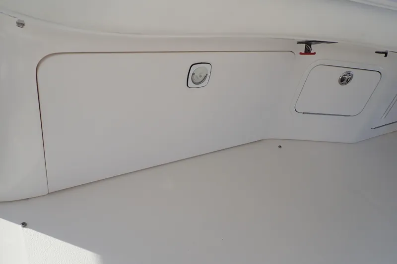Lattitude Adjustment Yacht Photos Pics 2003 Sea Ray 480 Sedan Bridge storage compartment with white interior and access panels.
