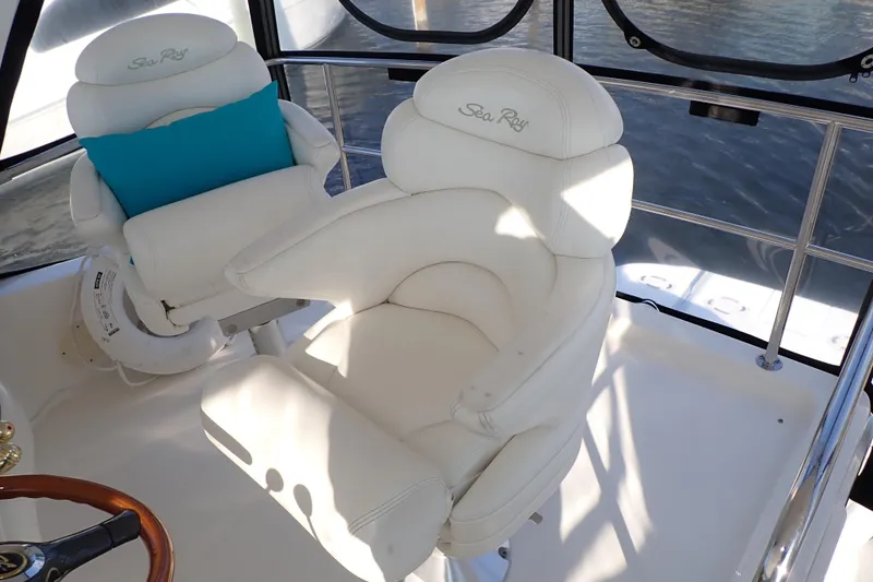 Lattitude Adjustment Yacht Photos Pics Captain's chairs on 2003 Sea Ray 480 Sedan Bridge yacht, featuring white upholstery and blue cushion.