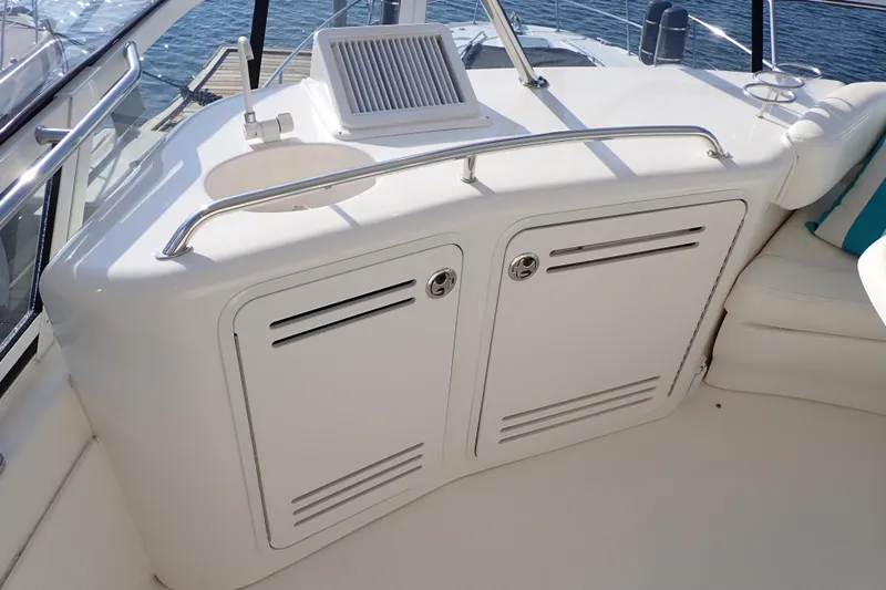 Lattitude Adjustment Yacht Photos Pics 2003 Sea Ray 480 Sedan Bridge yacht interior with sleek white cabinetry and seating.