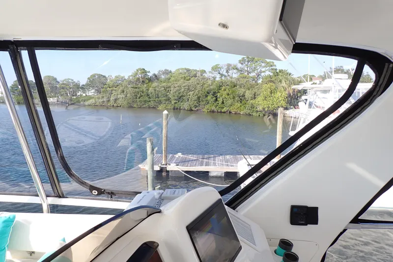 Lattitude Adjustment Yacht Photos Pics Interior view from 2003 Sea Ray 480 Sedan Bridge, overlooking serene waterfront and dock.