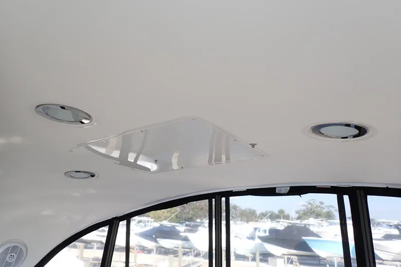 Lattitude Adjustment Yacht Photos Pics Ceiling view of 2003 Sea Ray 480 Sedan Bridge with recessed lighting and windows.