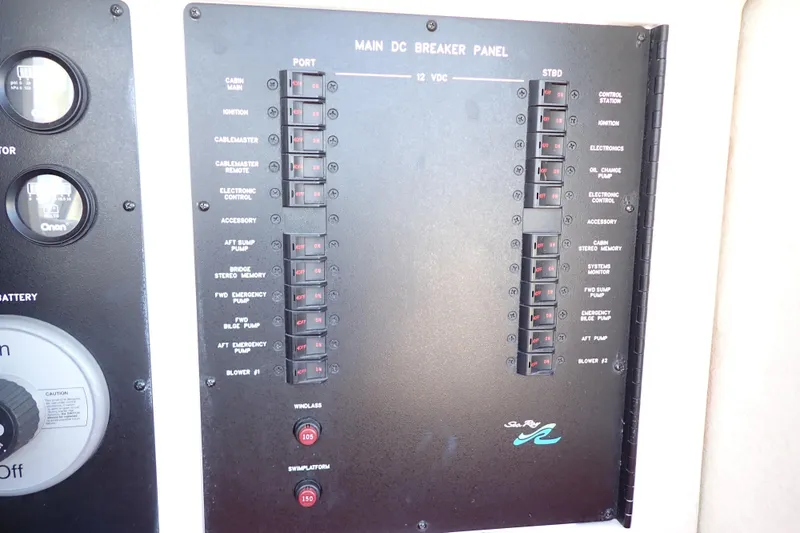 Lattitude Adjustment Yacht Photos Pics Main DC breaker panel on 2003 Sea Ray 480 Sedan Bridge yacht, showing switches and controls.