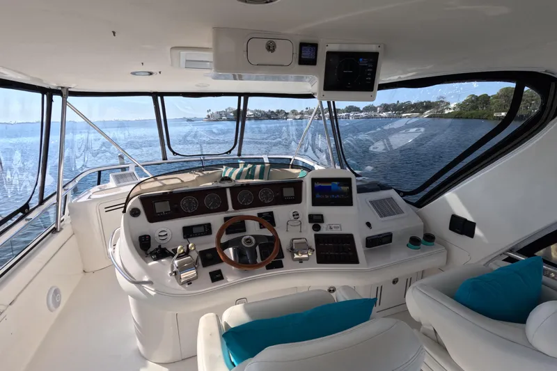Lattitude Adjustment Yacht Photos Pics Interior view of 2003 Sea Ray 480 Sedan Bridge yacht cockpit with scenic water backdrop.