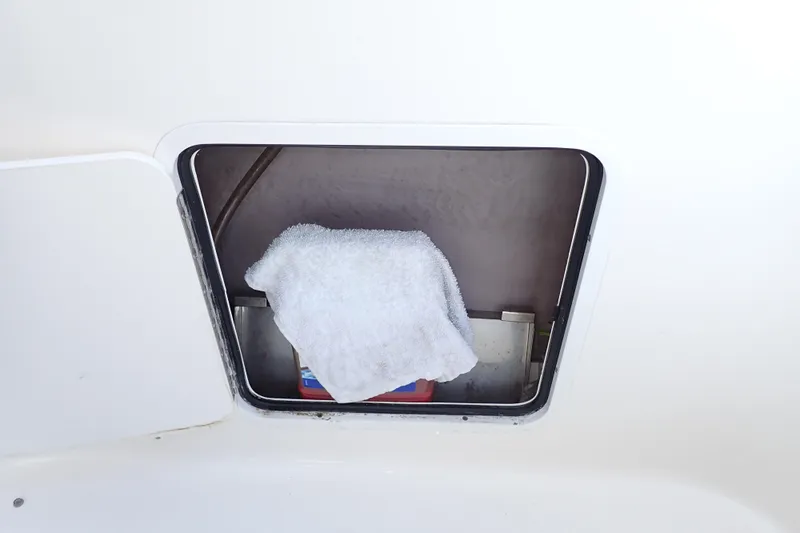 Lattitude Adjustment Yacht Photos Pics Storage compartment on a 2003 Sea Ray 480 Sedan Bridge with a towel inside.