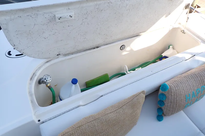 Lattitude Adjustment Yacht Photos Pics Storage compartment on 2003 Sea Ray 480 Sedan Bridge with cleaning supplies and cushions.