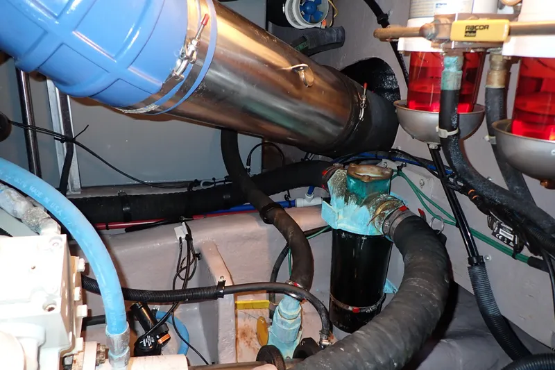 Lattitude Adjustment Yacht Photos Pics Engine room of 2003 Sea Ray 480 Sedan Bridge with visible pipes and filters.