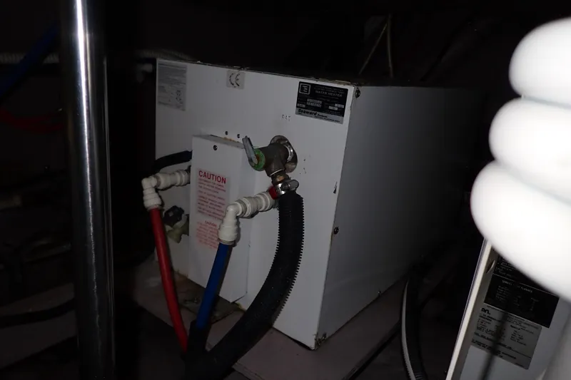 Lattitude Adjustment Yacht Photos Pics Engine room of 2003 Sea Ray 480 Sedan Bridge with water heater and pipes.