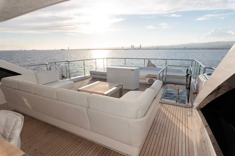 Nadira Yacht Photos Pics Luxurious 2019 Princess 30M yacht deck with white seating, ocean view, and sunset.