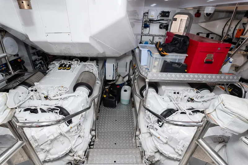 Nadira Yacht Photos Pics Engine room of a 2019 Princess 30M yacht, featuring dual engines and organized storage.