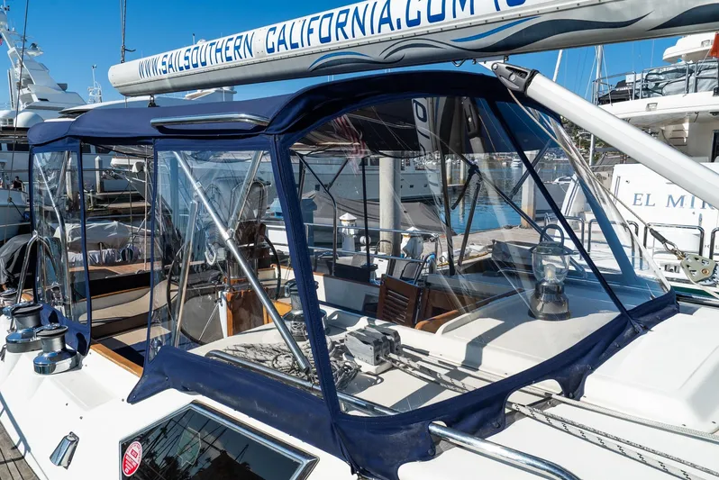 Majestic Yacht Photos Pics 2006 Tayana 58 Deck Saloon yacht with blue canopy in marina.