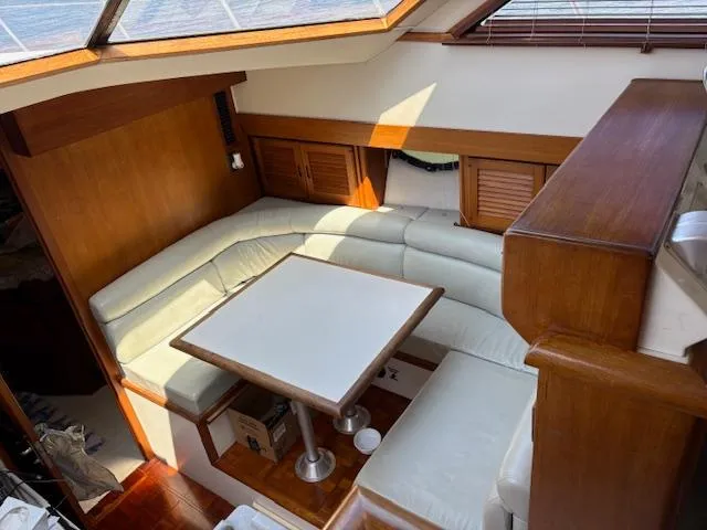  Yacht Photos Pics 1990 Carver Californian 52 yacht interior with white leather seating and wooden accents.
