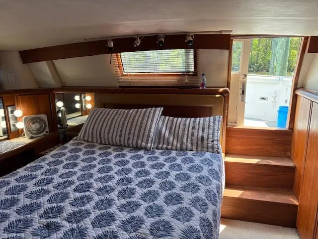  Yacht Photos Pics Bedroom interior of 1990 Carver Californian 52 yacht with cozy bed and natural light.