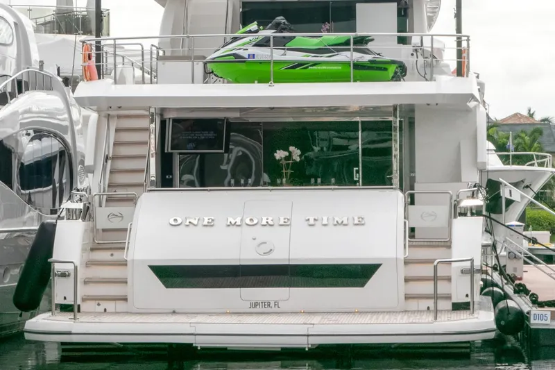 One More Time Yacht Photos Pics Luxury Horizon FD92 yacht with green jet ski, 2021 model, docked in marina.