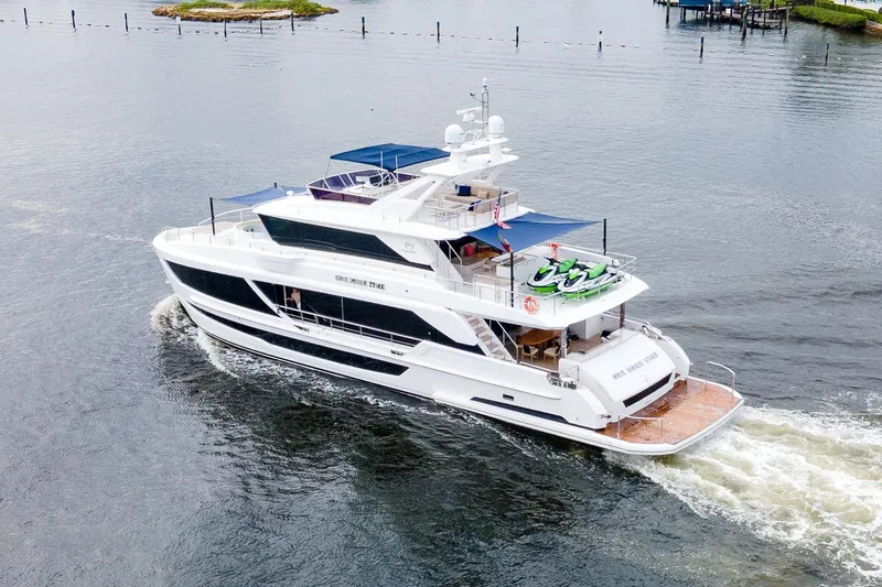 One More Time Yacht Photos Pics Luxurious 2021 Horizon FD92 yacht cruising on calm waters.