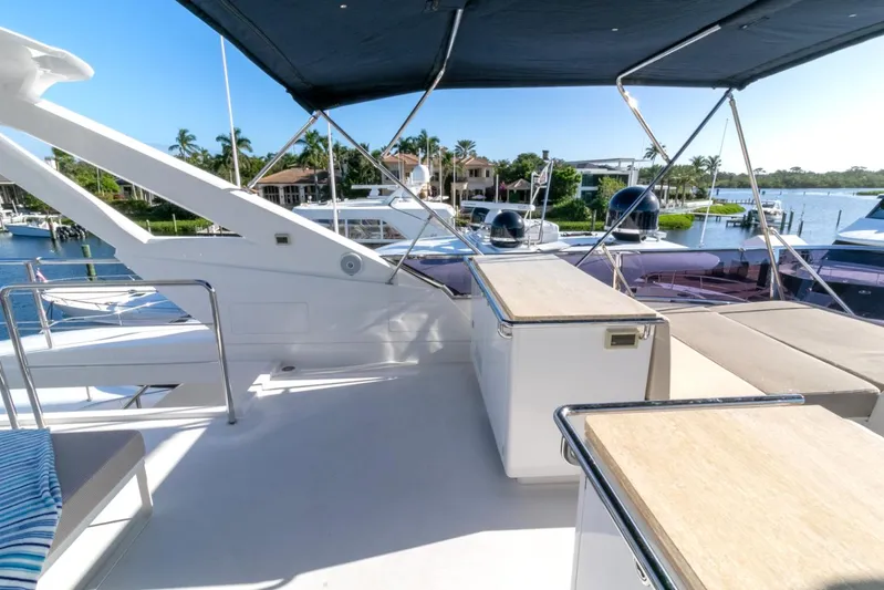 One More Time Yacht Photos Pics Luxury Horizon FD92 yacht deck with seating, 2021 model, docked in a scenic marina.