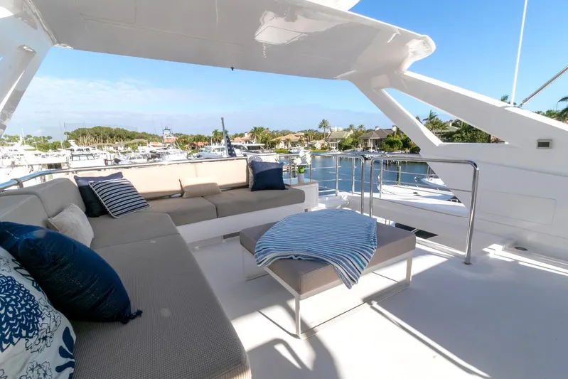 One More Time Yacht Photos Pics Luxurious Horizon FD92 yacht deck with comfortable seating, 2021 model, overlooking marina.