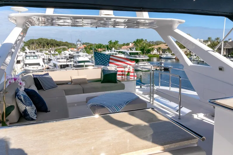 One More Time Yacht Photos Pics Luxurious Horizon FD92 yacht deck with seating, American flag, and marina view, 2021 model.