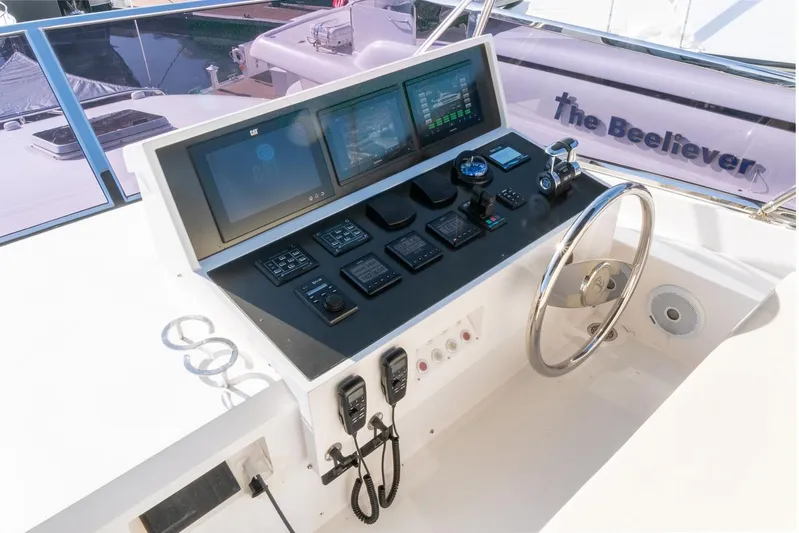 One More Time Yacht Photos Pics Horizon FD92 2021 yacht helm with modern navigation controls and steering wheel.
