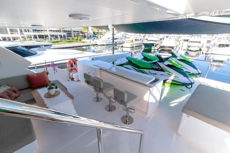 One More Time Yacht Photos Pics Luxurious Horizon FD92 yacht deck with seating, bar stools, and jet skis, 2021 model.