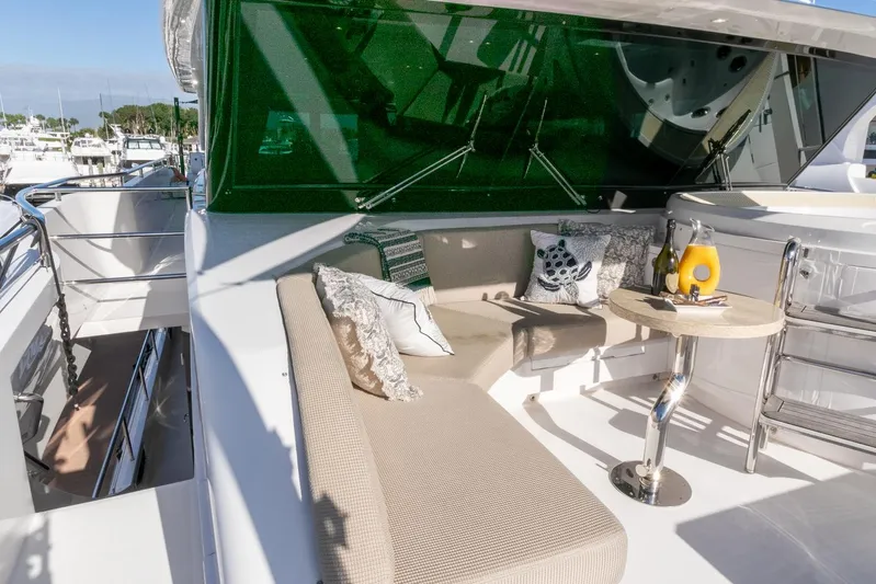 One More Time Yacht Photos Pics Luxurious Horizon FD92 yacht deck with seating, table, and green tinted windows, 2021 model.