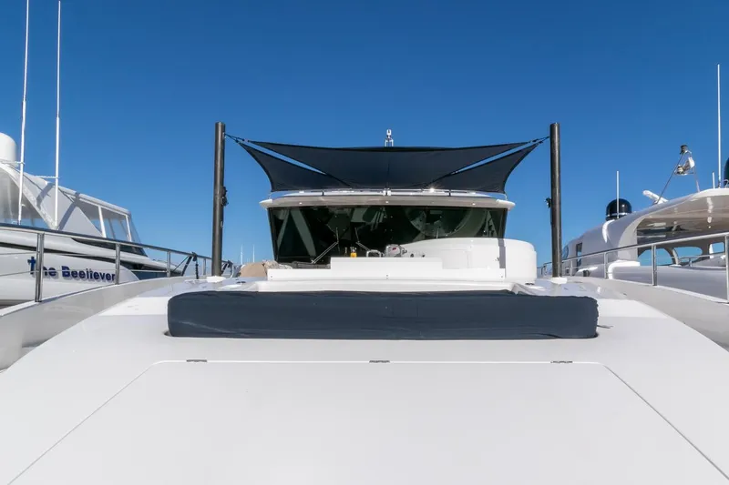 One More Time Yacht Photos Pics Luxury Horizon FD92 yacht, 2021 model, with sleek design and sunshade, under clear blue sky.