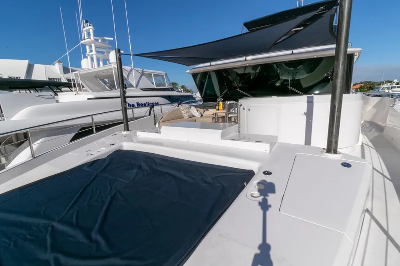 One More Time Yacht Photos Pics Luxury Horizon FD92 yacht deck with sunshade, 2021 model, docked alongside other boats.