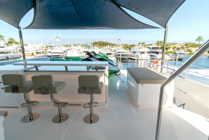 One More Time Yacht Photos Pics Luxury yacht deck with bar stools and marina view, Horizon FD92, 2021 model.