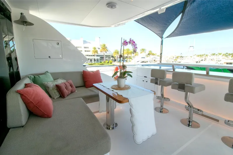 One More Time Yacht Photos Pics Luxurious Horizon FD92 yacht deck with seating, table, and bar stools, 2021 model.