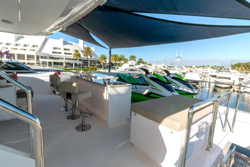 One More Time Yacht Photos Pics Luxury yacht deck with seating, shade canopy, and marina view; Horizon FD92, 2021 model.