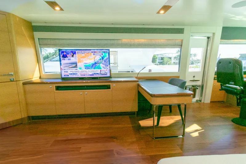 One More Time Yacht Photos Pics Luxurious Horizon FD92 yacht interior with TV, desk, and panoramic window, 2021 model.