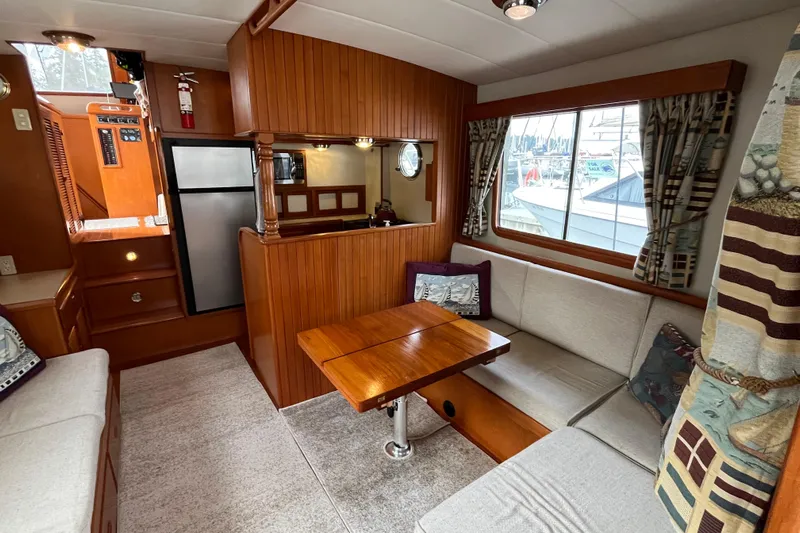 Abina Yacht Photos Pics Interior of 2001 Kadey-Krogen 39 yacht with cozy seating and wooden accents.