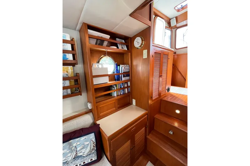 Abina Yacht Photos Pics Interior of 2001 Kadey-Krogen 39 yacht with wooden cabinetry and shelving.