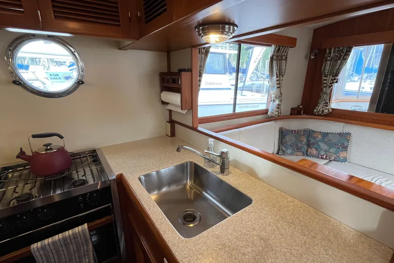 Abina Yacht Photos Pics Cozy 2001 Kadey-Krogen 39 yacht interior with kitchen and seating area.