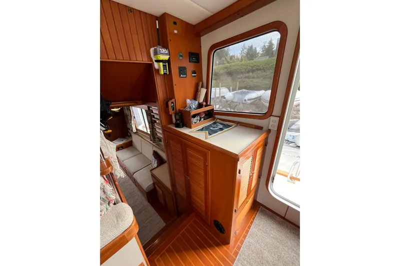 Abina Yacht Photos Pics Interior of 2001 Kadey-Krogen 39 yacht with wooden cabinetry and large window.