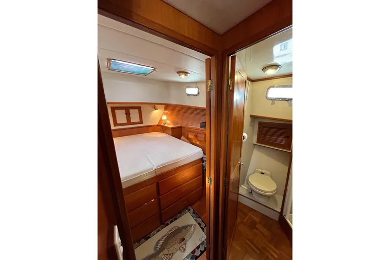 Abina Yacht Photos Pics Cozy cabin interior of 2001 Kadey-Krogen 39 yacht with bed and bathroom.