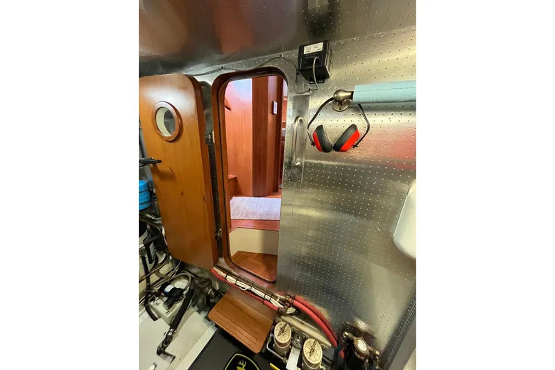 Abina Yacht Photos Pics Engine room of 2001 Kadey-Krogen 39 yacht with wooden door and safety equipment.