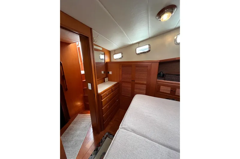 Abina Yacht Photos Pics Interior of 2001 Kadey-Krogen 39 yacht with wooden cabinetry and cozy bedroom.
