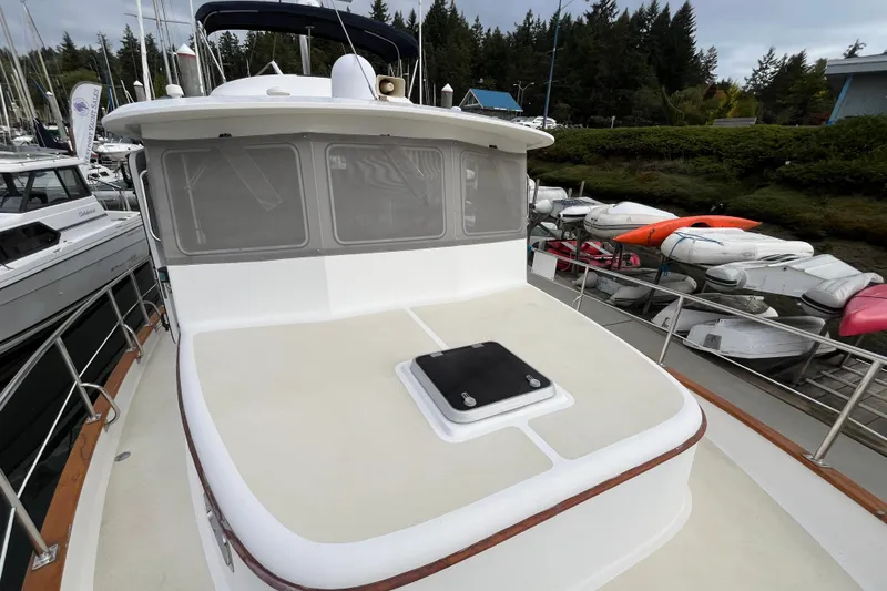 Abina Yacht Photos Pics 2001 Kadey-Krogen 39 yacht docked, showcasing spacious deck and sleek design.