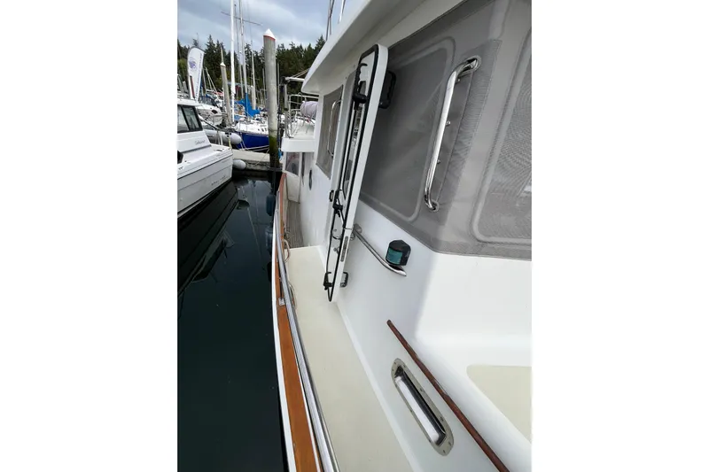 Abina Yacht Photos Pics 2001 Kadey-Krogen 39 yacht docked, showcasing side deck and railing details.