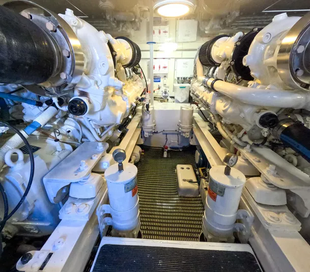 Farmers Daughter Yacht Photos Pics Engine room of a 2004 Viking 45 Convertible yacht, showcasing dual engines and mechanical components.
