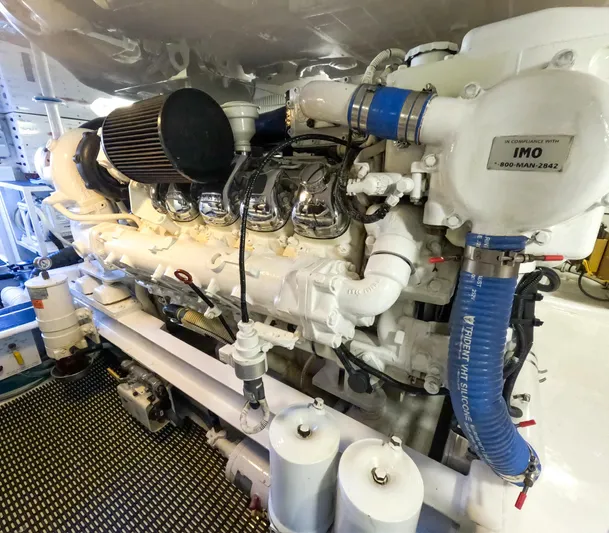 Farmers Daughter Yacht Photos Pics Engine room of a 2004 Viking 45 Convertible yacht, showcasing detailed machinery.