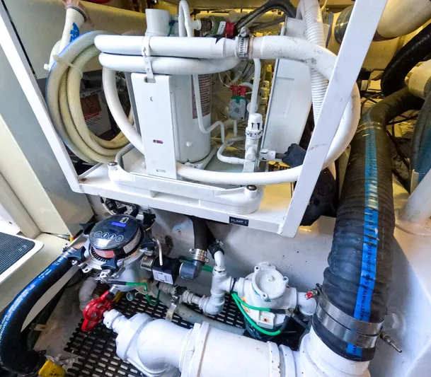 Farmers Daughter Yacht Photos Pics Engine room of 2004 Viking 45 Convertible yacht, showcasing complex piping and machinery.